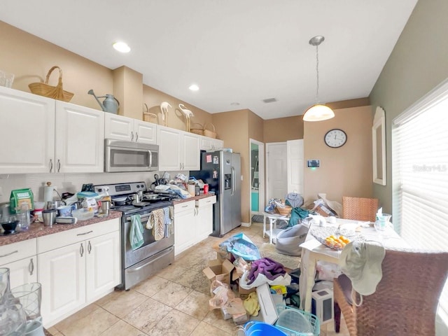 kitchen featuring pendant lighting, white cabinetry, and appliances with stainless steel finishes