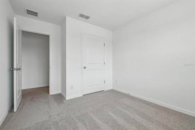 unfurnished bedroom with light colored carpet