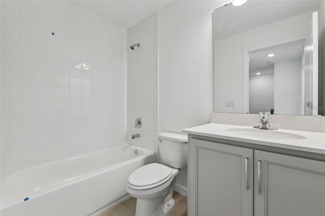 full bathroom featuring tiled shower / bath, vanity, toilet, and tile patterned flooring