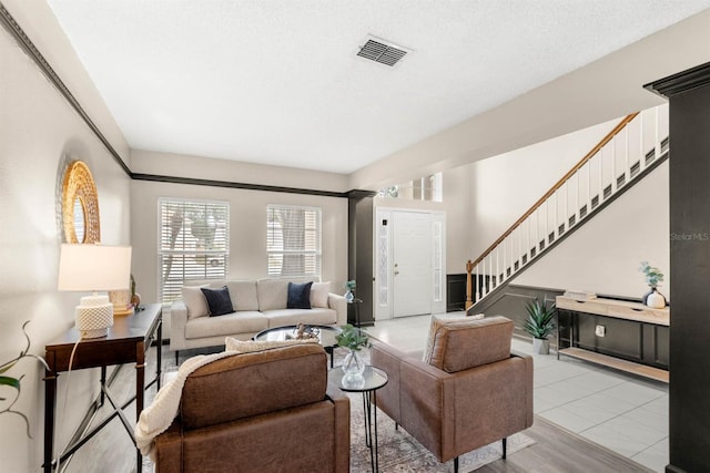 living room featuring a textured ceiling and light wood-type flooring