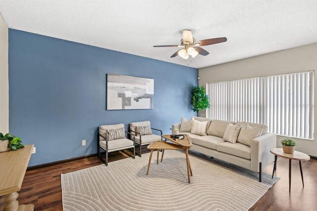 living room featuring a textured ceiling, ceiling fan, and dark hardwood / wood-style floors