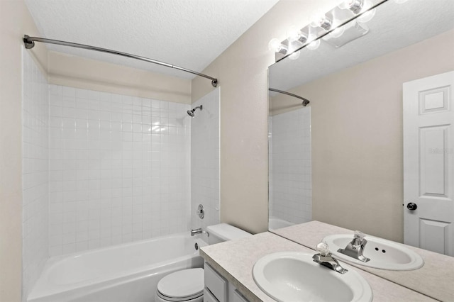 full bathroom featuring vanity, shower / bathtub combination, toilet, and a textured ceiling