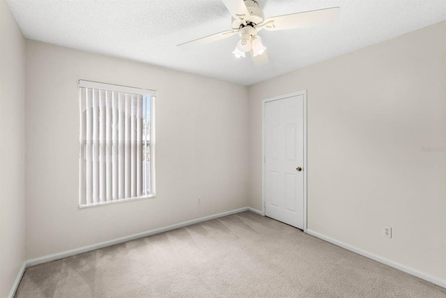 unfurnished room with carpet and ceiling fan