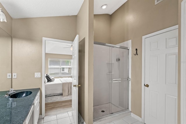 bathroom with tile patterned floors, vanity, and an enclosed shower