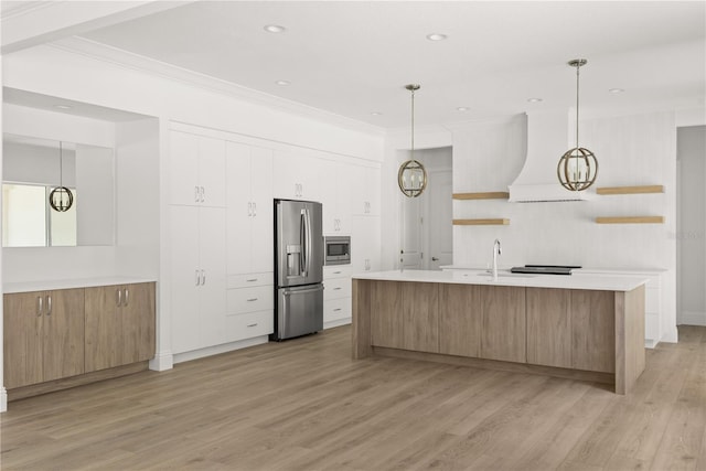 kitchen with stainless steel appliances, white cabinetry, premium range hood, and pendant lighting