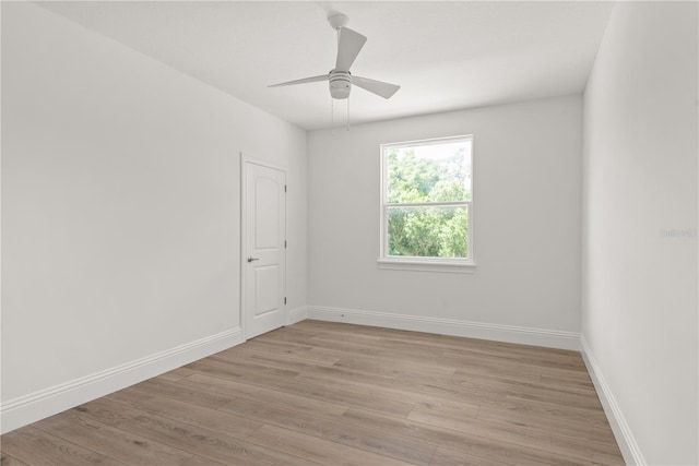 spare room featuring light hardwood / wood-style floors and ceiling fan