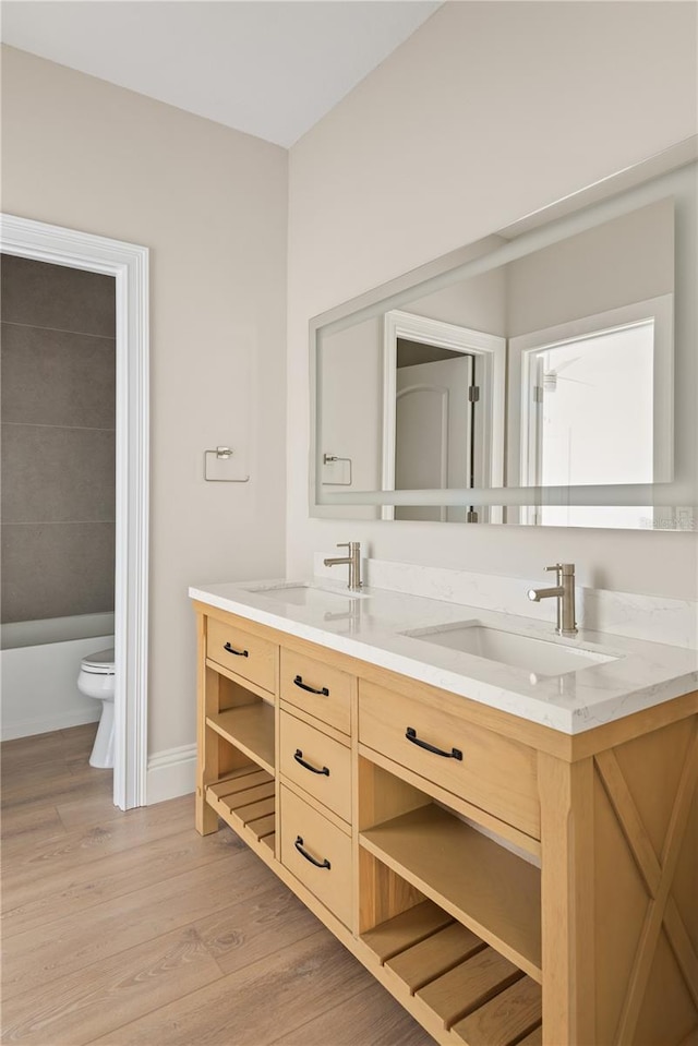 bathroom featuring vanity, hardwood / wood-style floors, and toilet