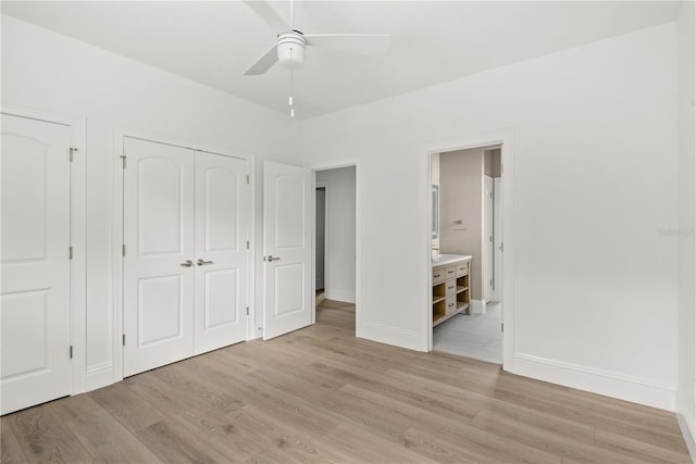 unfurnished bedroom with ceiling fan, connected bathroom, light hardwood / wood-style floors, and a closet