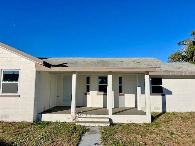 view of exterior entry with covered porch