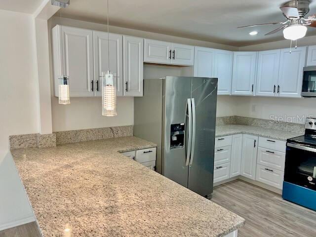 kitchen with white cabinets, ceiling fan, light wood-type flooring, and stainless steel appliances