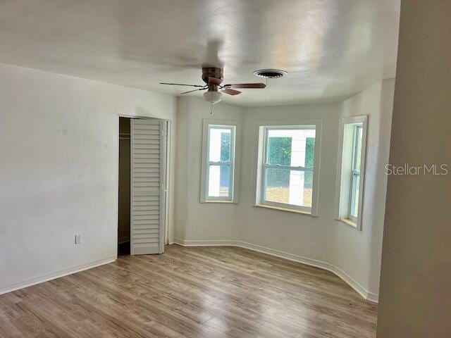 unfurnished bedroom featuring ceiling fan and light hardwood / wood-style flooring