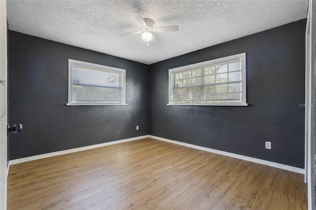 unfurnished room with ceiling fan, light hardwood / wood-style floors, and a textured ceiling