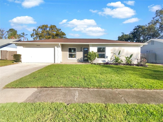 ranch-style home with a front yard and a garage