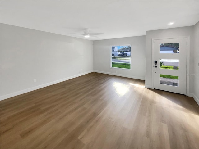 unfurnished living room with hardwood / wood-style flooring and ceiling fan