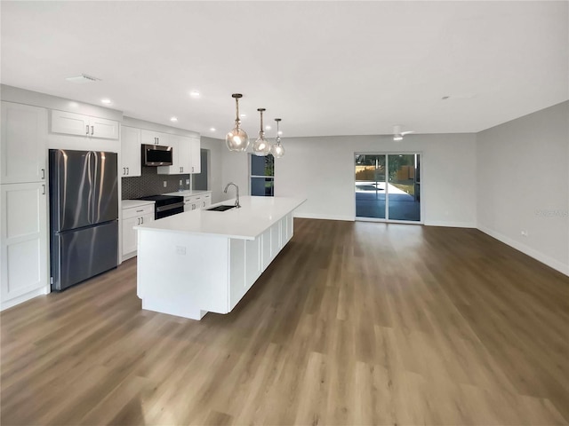 kitchen featuring a kitchen island with sink, black appliances, decorative light fixtures, dark hardwood / wood-style floors, and white cabinetry