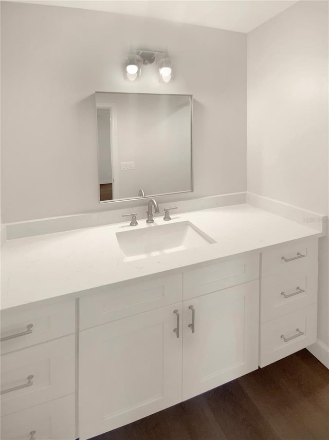 bathroom with hardwood / wood-style floors and vanity