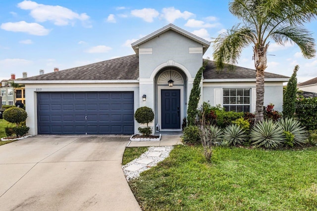 view of front of home with a garage and a front lawn