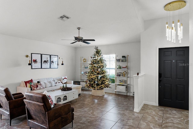 living room featuring ceiling fan with notable chandelier