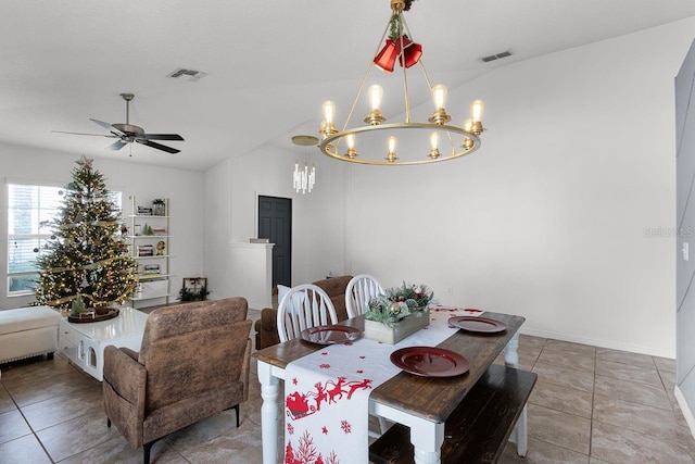 tiled dining space with ceiling fan with notable chandelier and vaulted ceiling