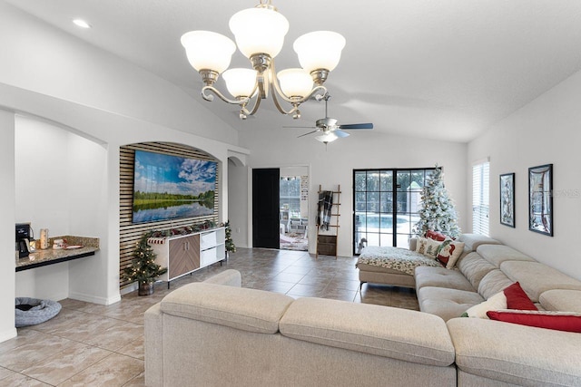 tiled living room with ceiling fan with notable chandelier and lofted ceiling