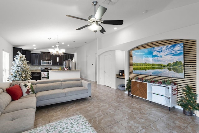 tiled living room with ceiling fan with notable chandelier