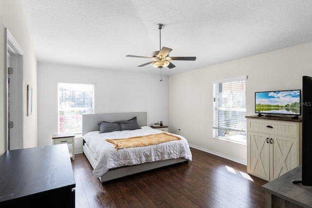 bedroom featuring multiple windows, ceiling fan, and dark hardwood / wood-style flooring