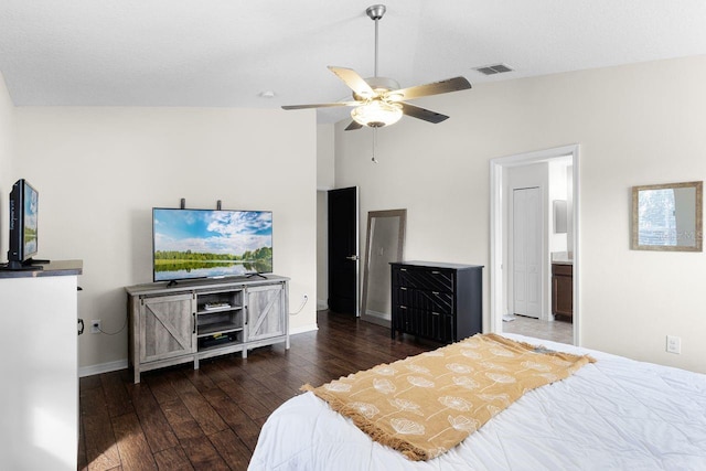 bedroom with ensuite bath, dark hardwood / wood-style floors, vaulted ceiling, and ceiling fan