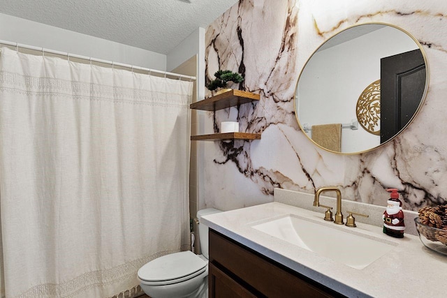 bathroom with vanity, a textured ceiling, and toilet