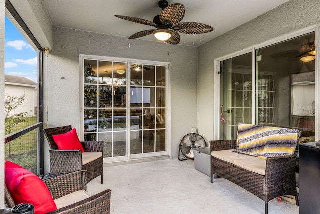 sunroom / solarium featuring ceiling fan