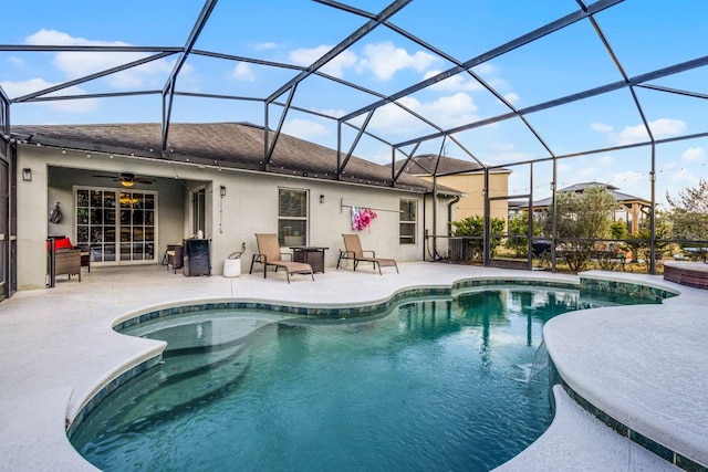 view of swimming pool with ceiling fan, a patio area, and a lanai