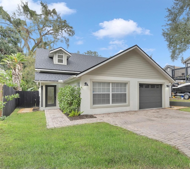 view of front of home featuring a garage and a front lawn