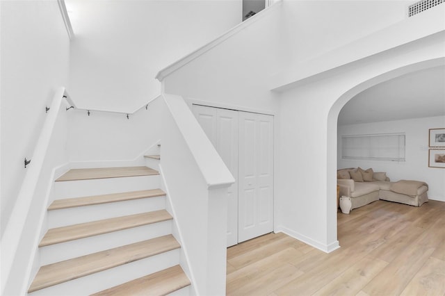 stairway with hardwood / wood-style floors