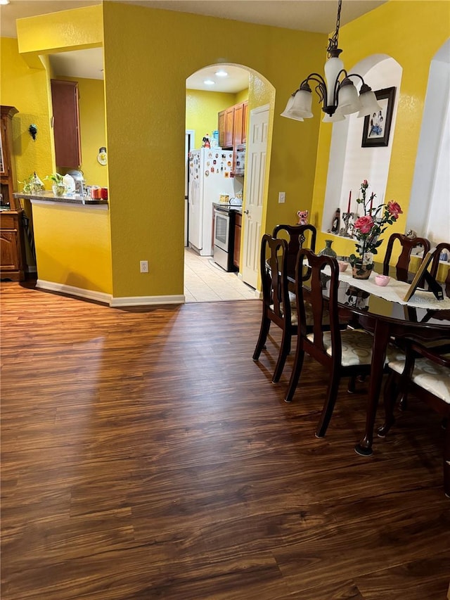 dining area featuring a notable chandelier and light hardwood / wood-style floors