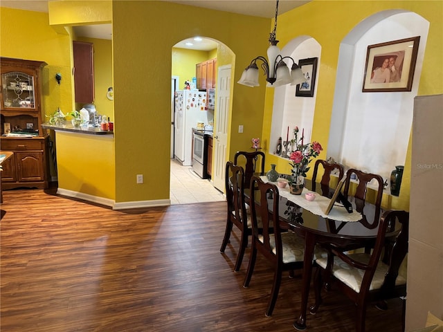 dining space with a chandelier and light wood-type flooring