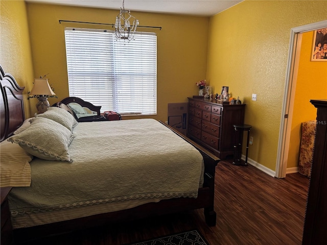 bedroom with multiple windows, dark wood-type flooring, and a notable chandelier