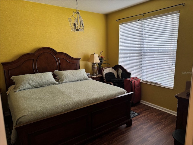 bedroom featuring a notable chandelier and dark hardwood / wood-style floors