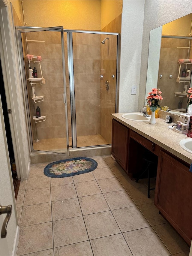 bathroom with tile patterned floors, vanity, and an enclosed shower