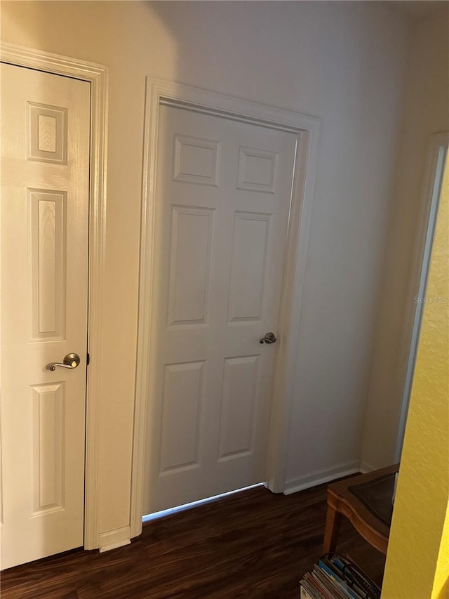 corridor featuring dark wood-type flooring