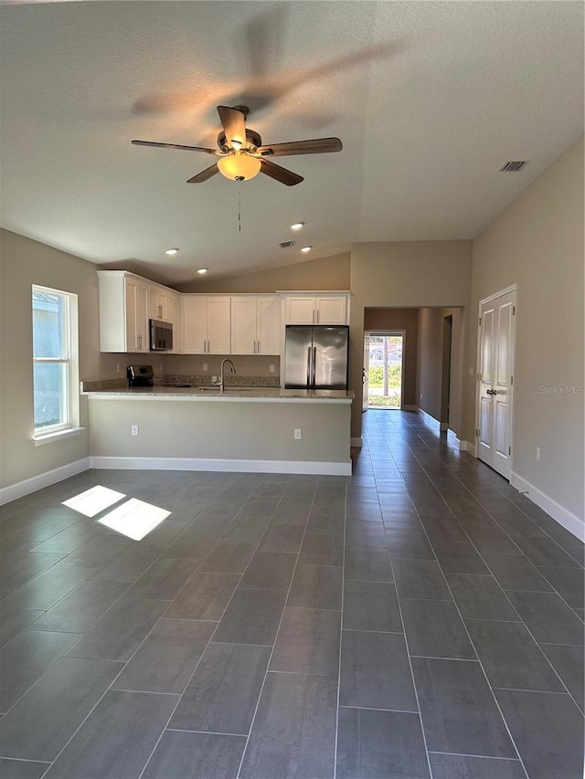 kitchen featuring sink, ceiling fan, stainless steel appliances, white cabinets, and kitchen peninsula