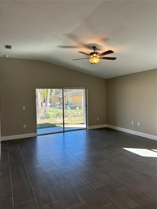 unfurnished room featuring lofted ceiling, a textured ceiling, and ceiling fan