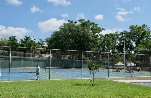 view of sport court featuring a yard