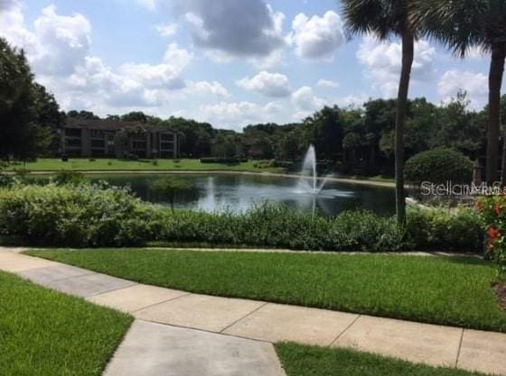 surrounding community featuring a yard and a water view