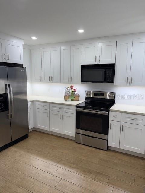 kitchen with appliances with stainless steel finishes and white cabinetry