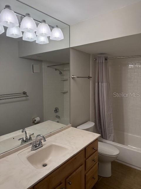 full bathroom with hardwood / wood-style floors, vanity, shower / bath combo, and toilet