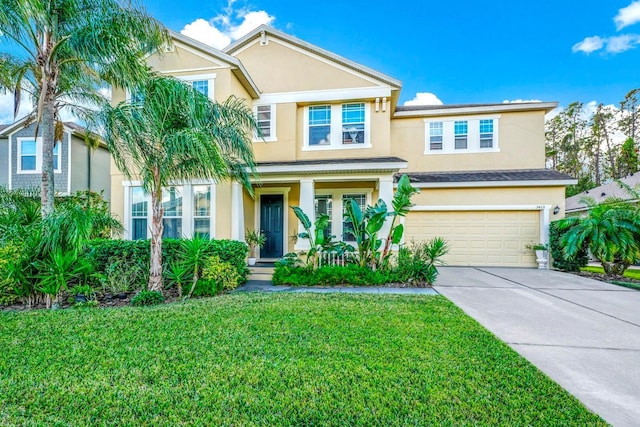 view of front of property with a front yard and a garage