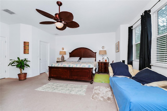 bedroom with ceiling fan and light colored carpet