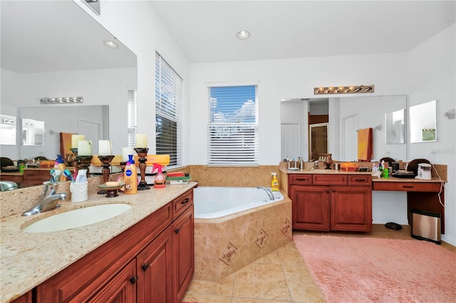 bathroom featuring tile patterned flooring, vanity, and shower with separate bathtub