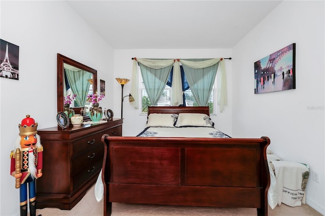 bedroom featuring light carpet