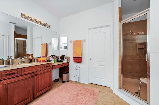 bathroom with tile patterned floors, a shower with door, and vanity