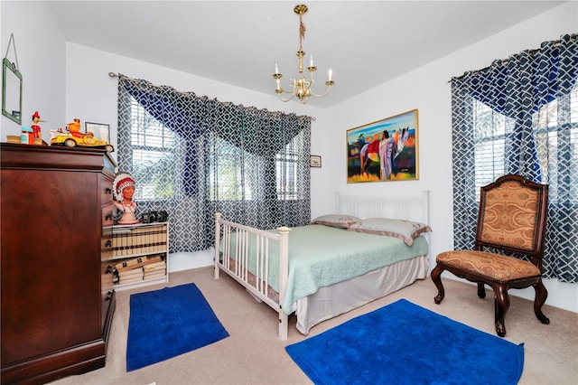 carpeted bedroom featuring a chandelier and multiple windows